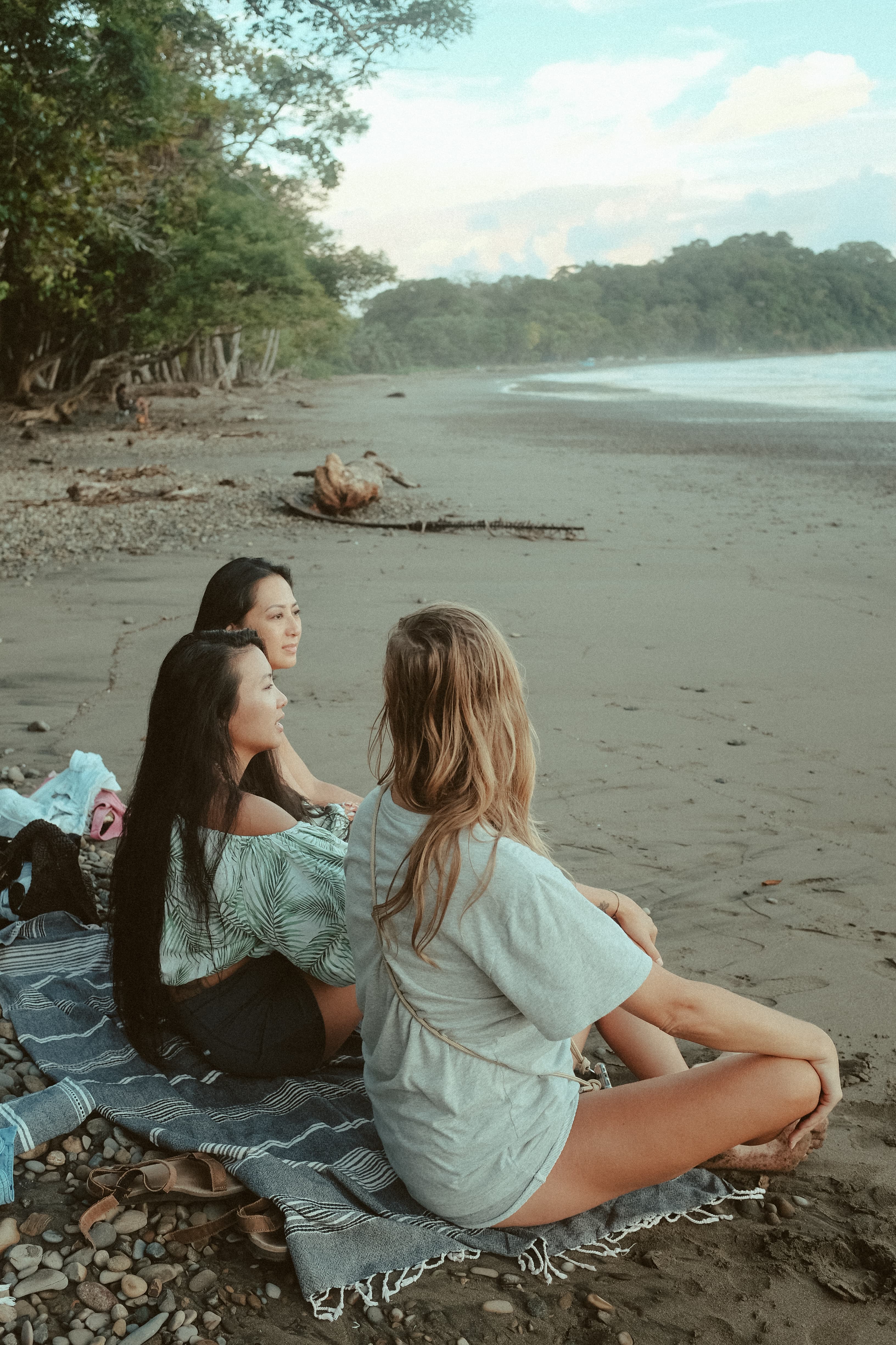 three women on the beach watching the pacific in costa rica