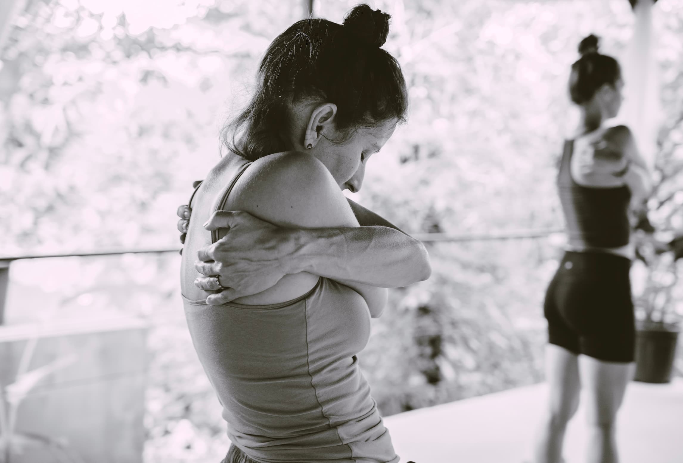 woman in a self embrace at a ryme retreat
